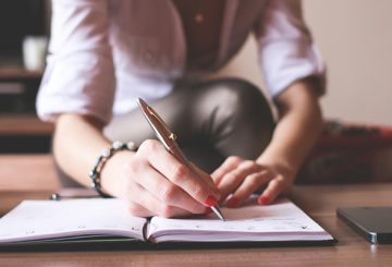 a person writing in a notebook