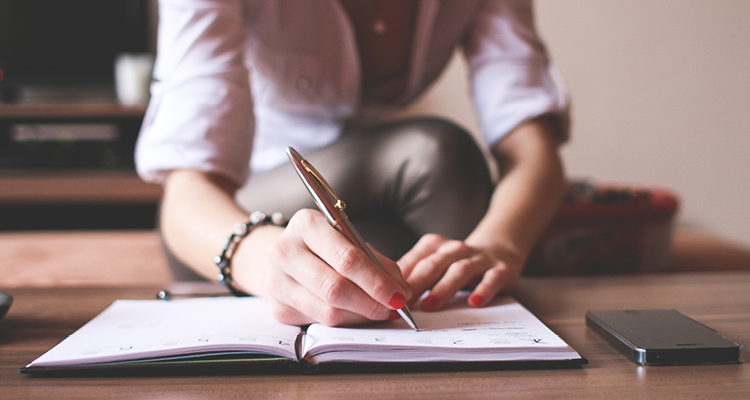 a person writing in a notebook