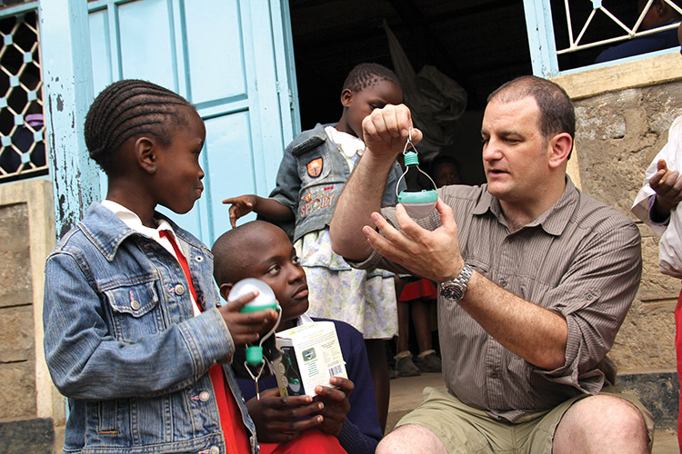 Steve Katsaros shows his solar powered lights to children
