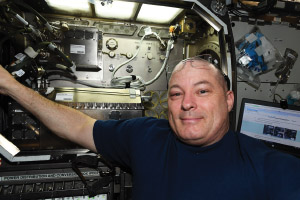 Tingle sets up the Microgravity Science Glovebox for the Trans-Alloy experiment.