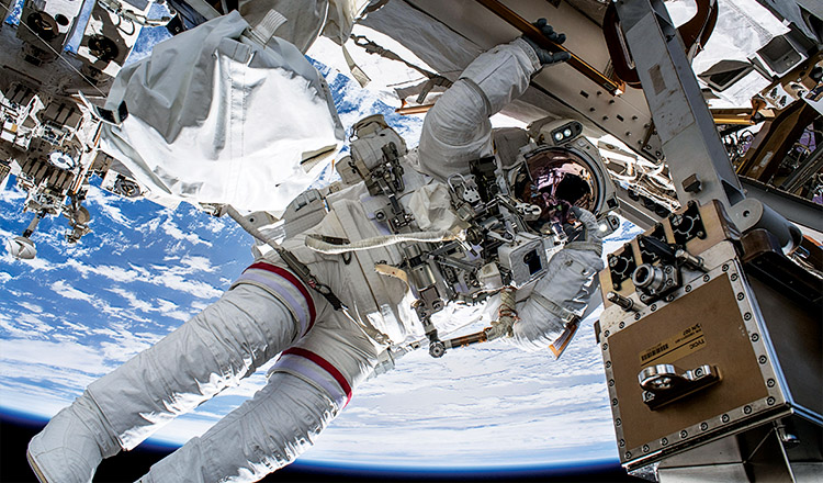 Astronaut Drew Feustel conducts a spacewalk off the International Space