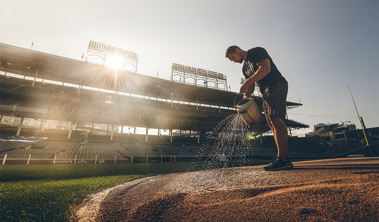 Dan Kiermaier waters the pitcher’s mound at Wrigley Field in Chicago.