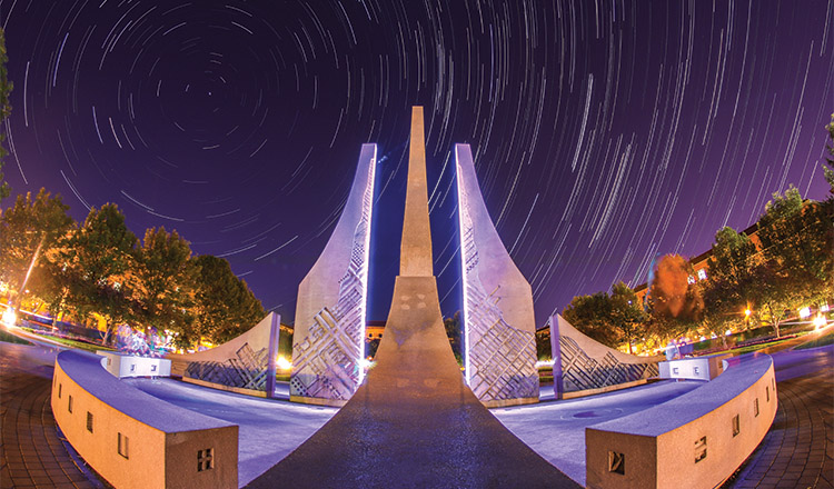 timelapse exposure of the night sky with the engineering fountain in the foreground